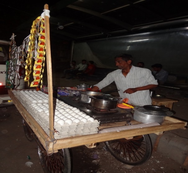 A vendor at the food cart set up with SWA's help
